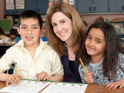 An alumni volunteer with 2 students